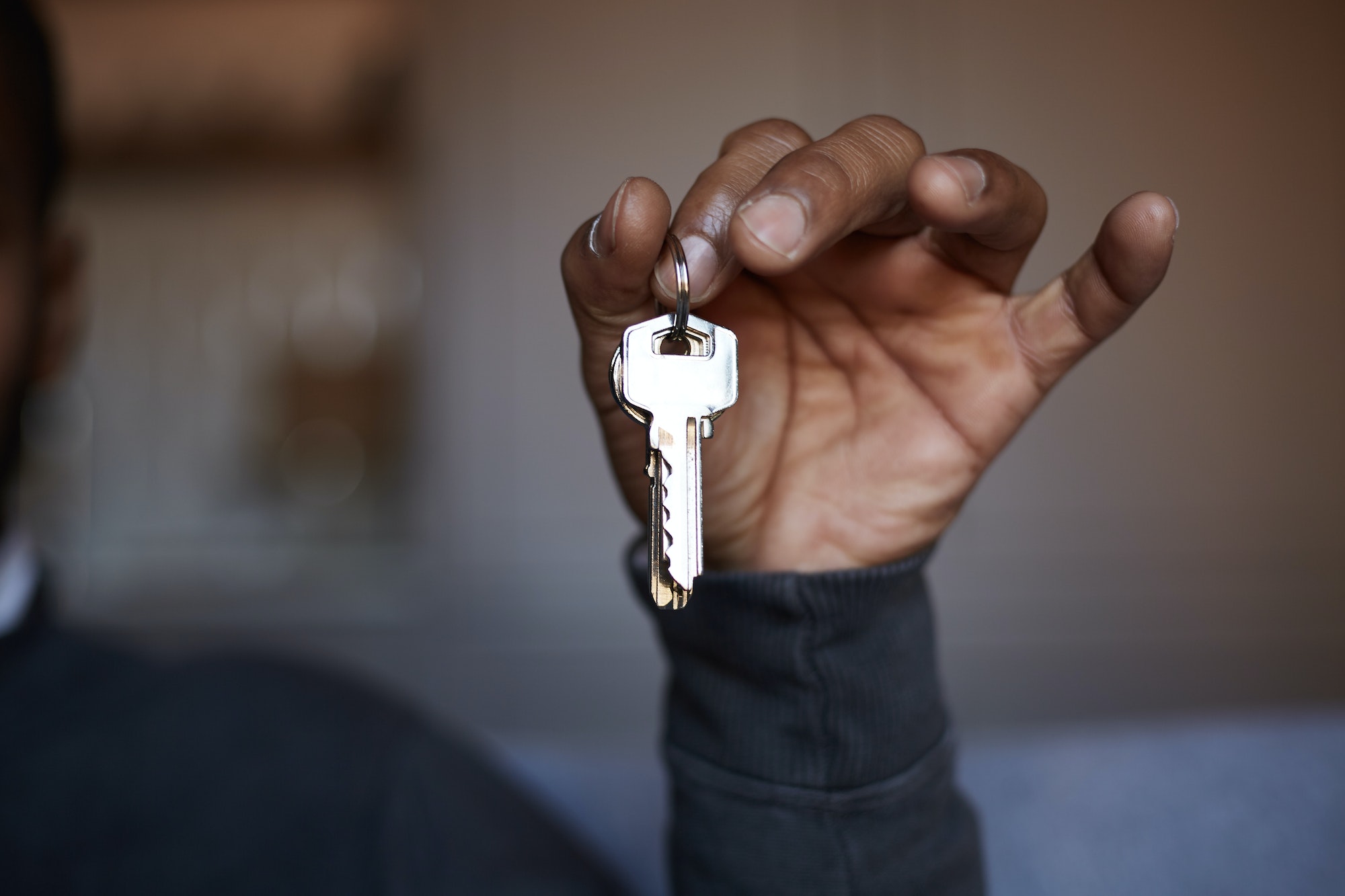 African black man holding home keys in hand