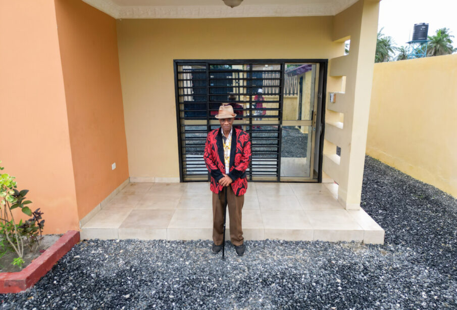 Kargbo standing at the entrance of his Jobomax Home in Newton, Sierra Leone