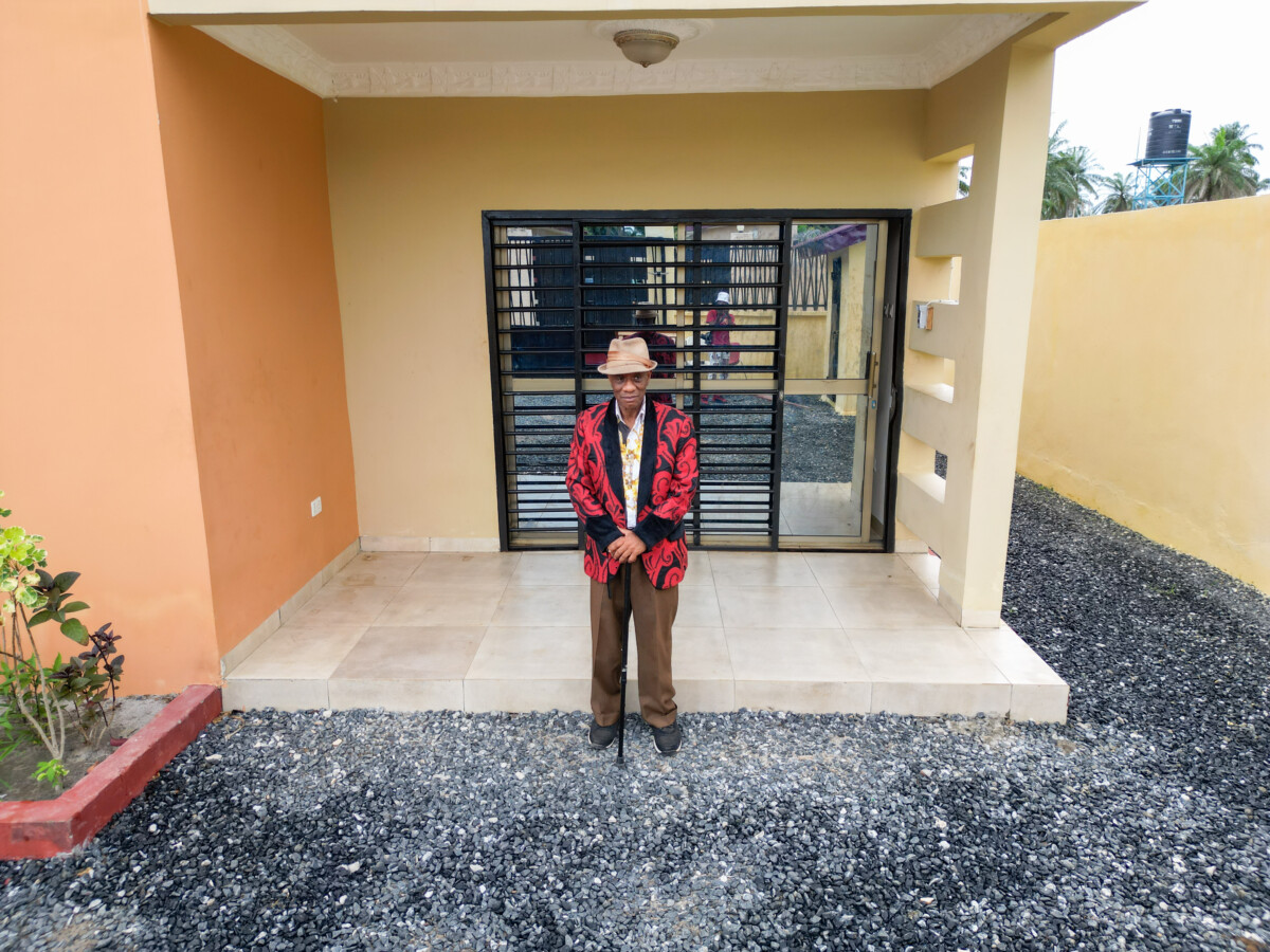 Kargbo standing at the entrance of his Jobomax Home in Newton, Sierra Leone